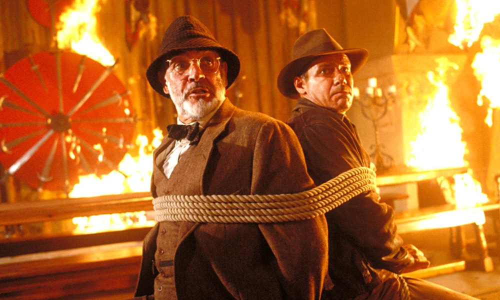 Henry Jones Sr and Indiana Jones are tied to a chair in The Last Crusade
